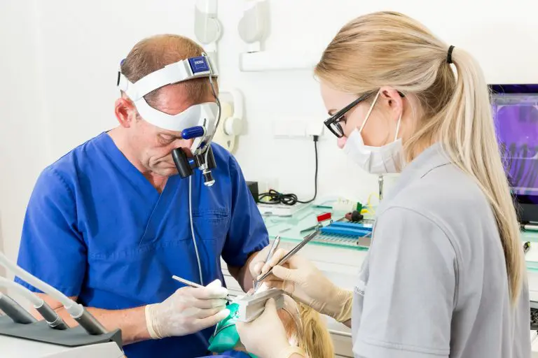Zahnarzt und Zahnarzthelferin bei der Behandlung eines Patienten zum Thema Parodontitis